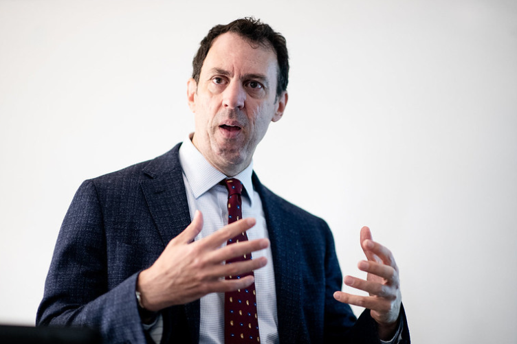 UNH Associate Professor Stephen Ciccone leads a lecture at the front of the classroom. 